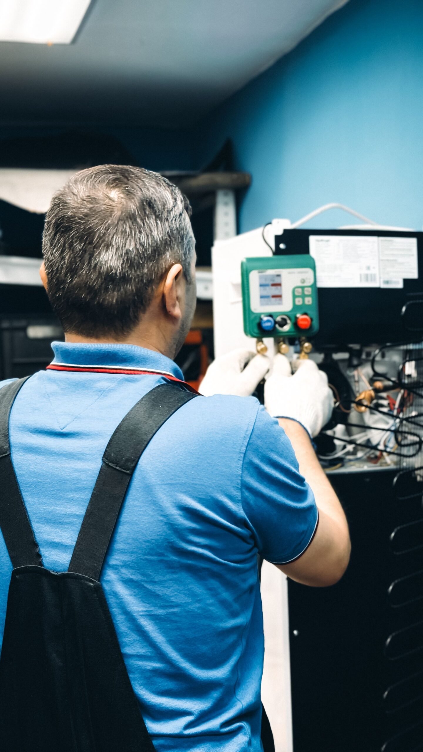 AC technician running diagnostics on an air conditioning unit