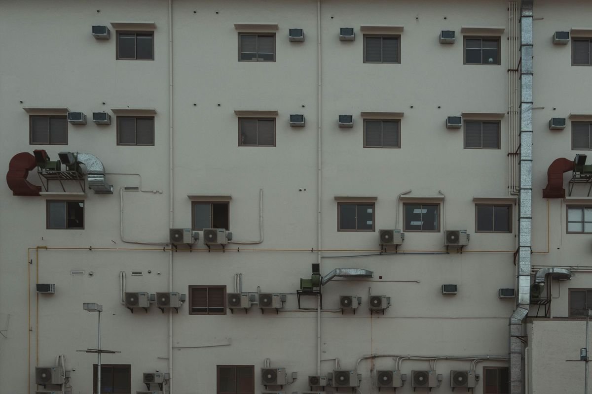 Building facade with multiple AC units and ducts