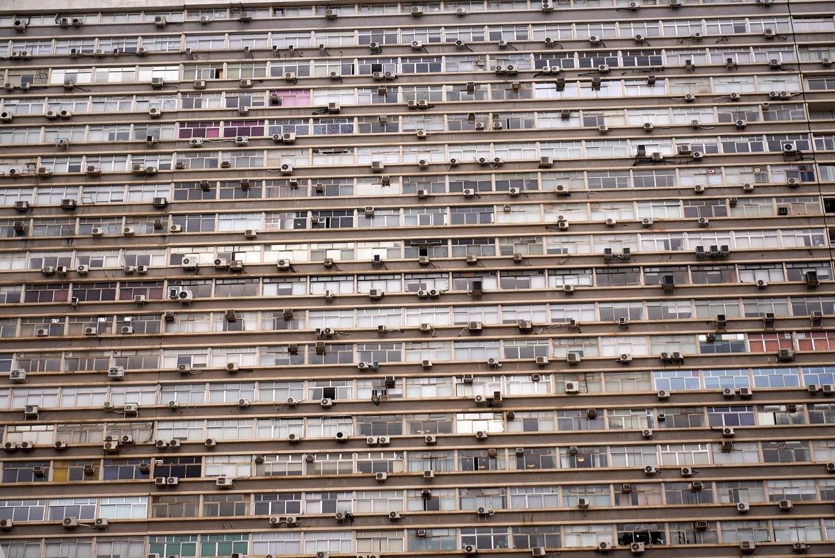High-rise building facade filled with AC units