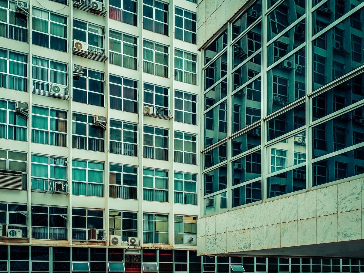 AC units on windows of a glass building