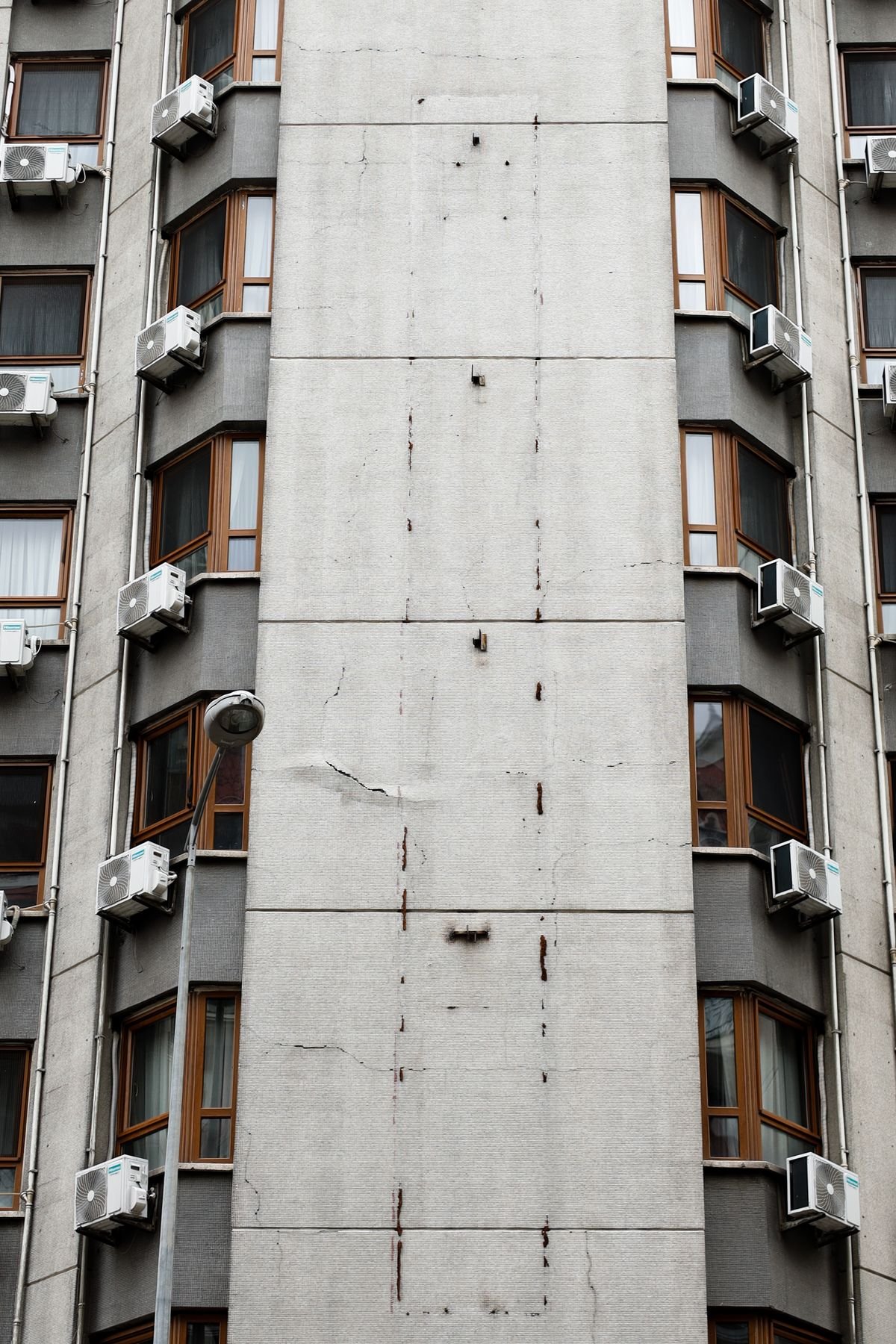 High-rise building facade with multiple air conditioners