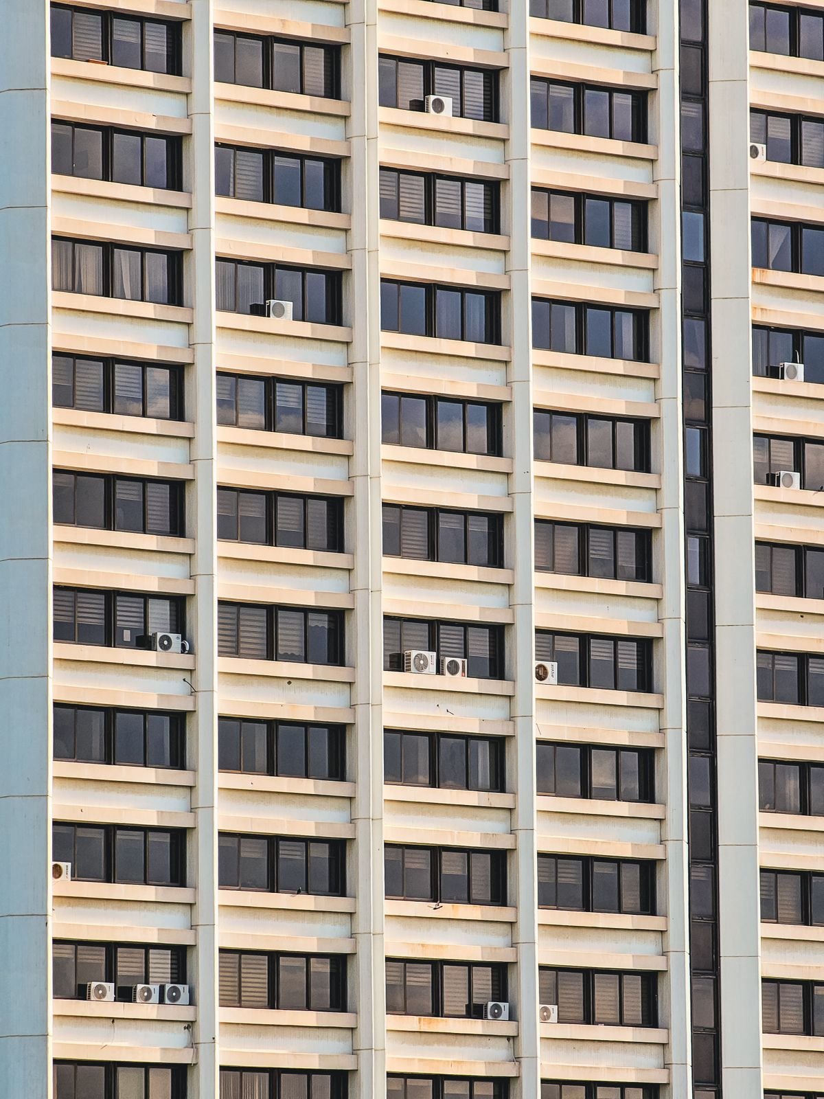 Apartment building wall with symmetrical AC units