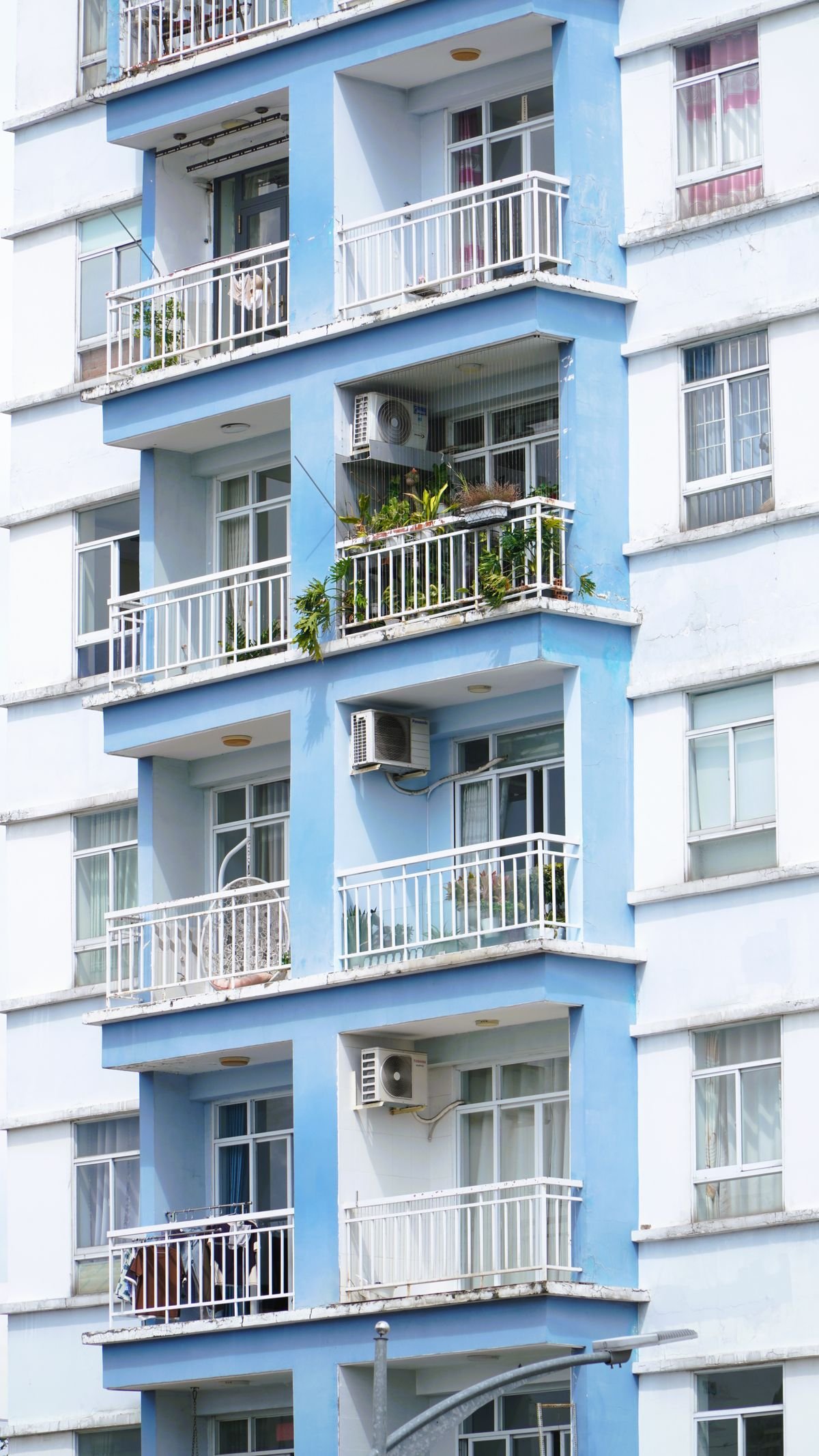 Modern apartment building with balconies and air conditioners