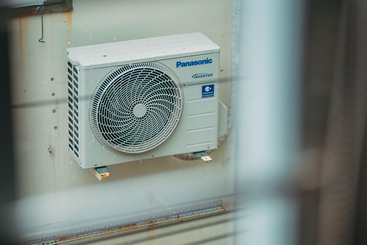 Air conditioning unit mounted outdoors on a building wall