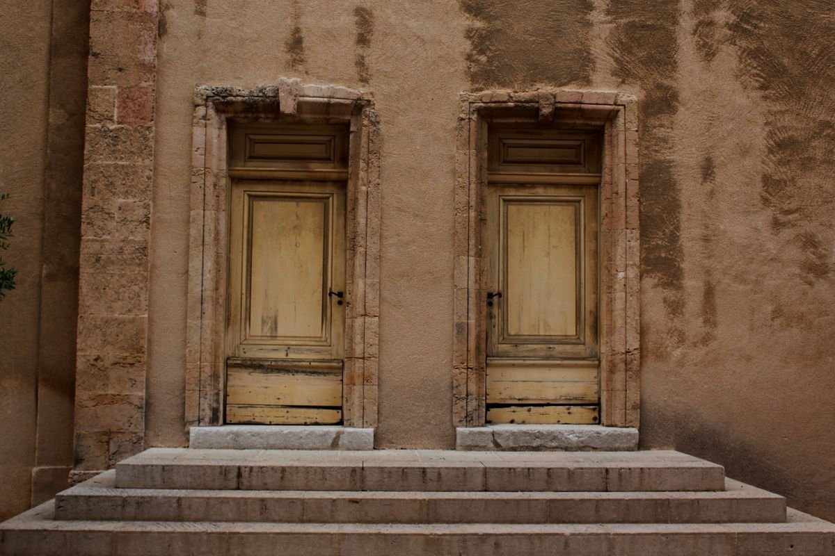 Pair of wooden doors set into a stone building facade