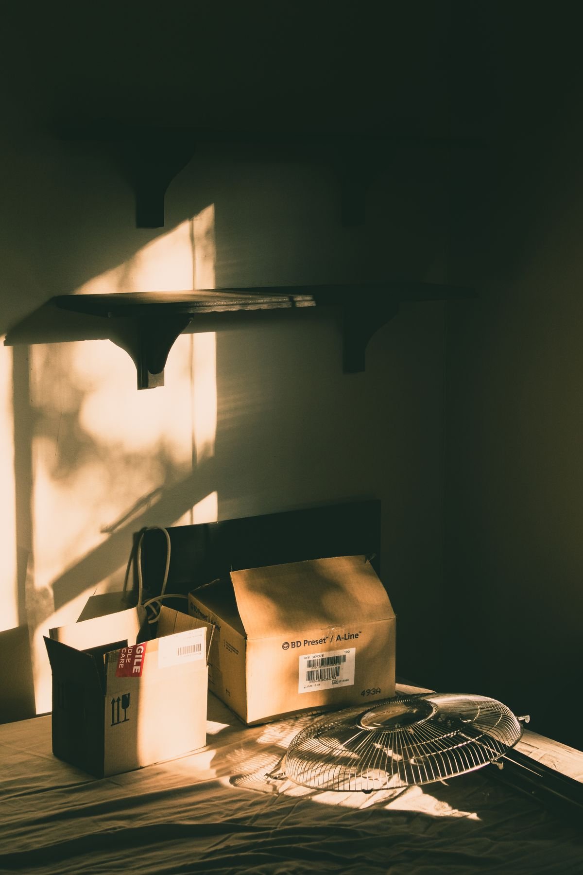 Cardboard boxes on a table lit by warm sunlight, representing a move-out setting