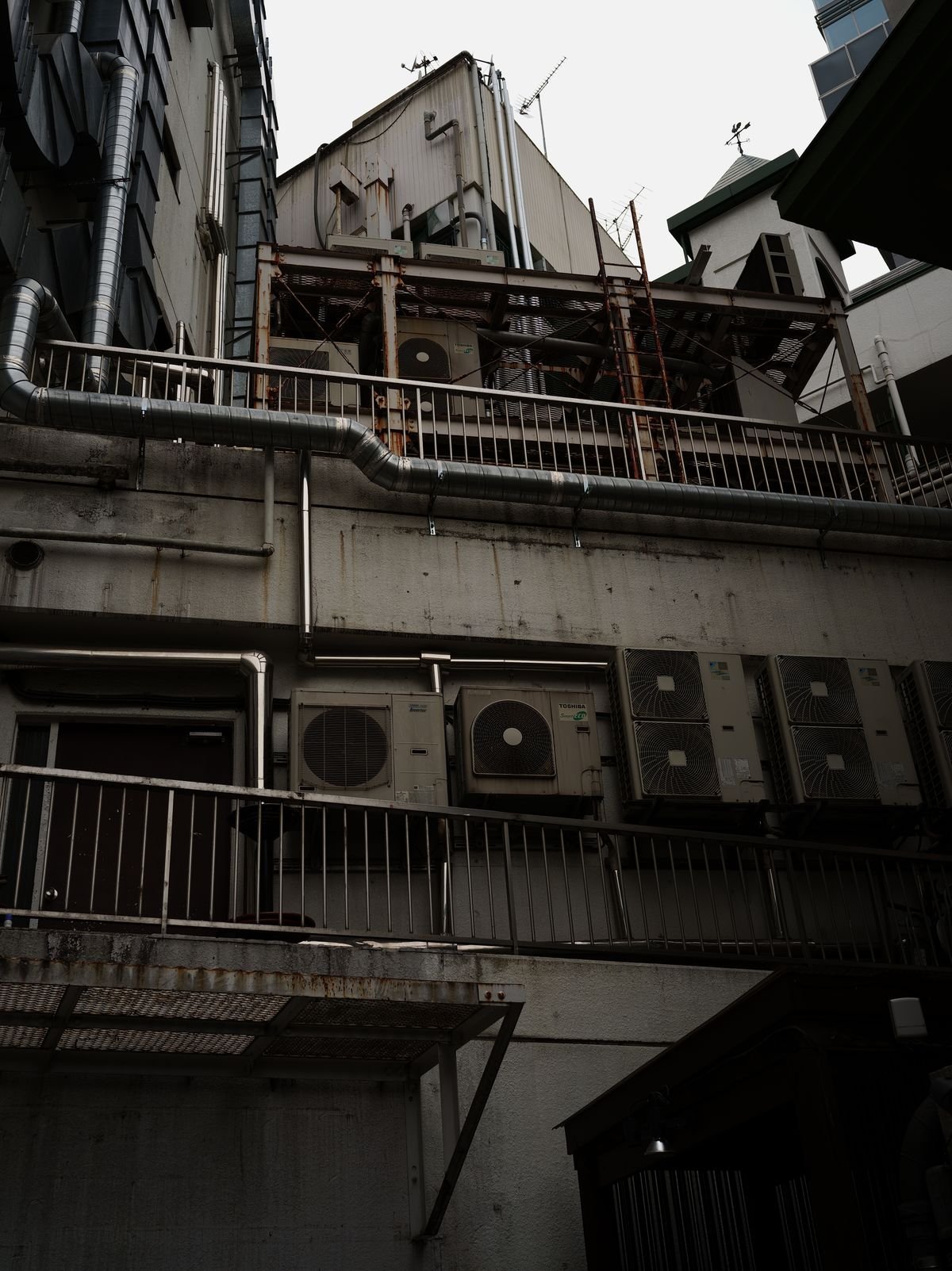 Low angle view of HVAC units mounted on a building wall