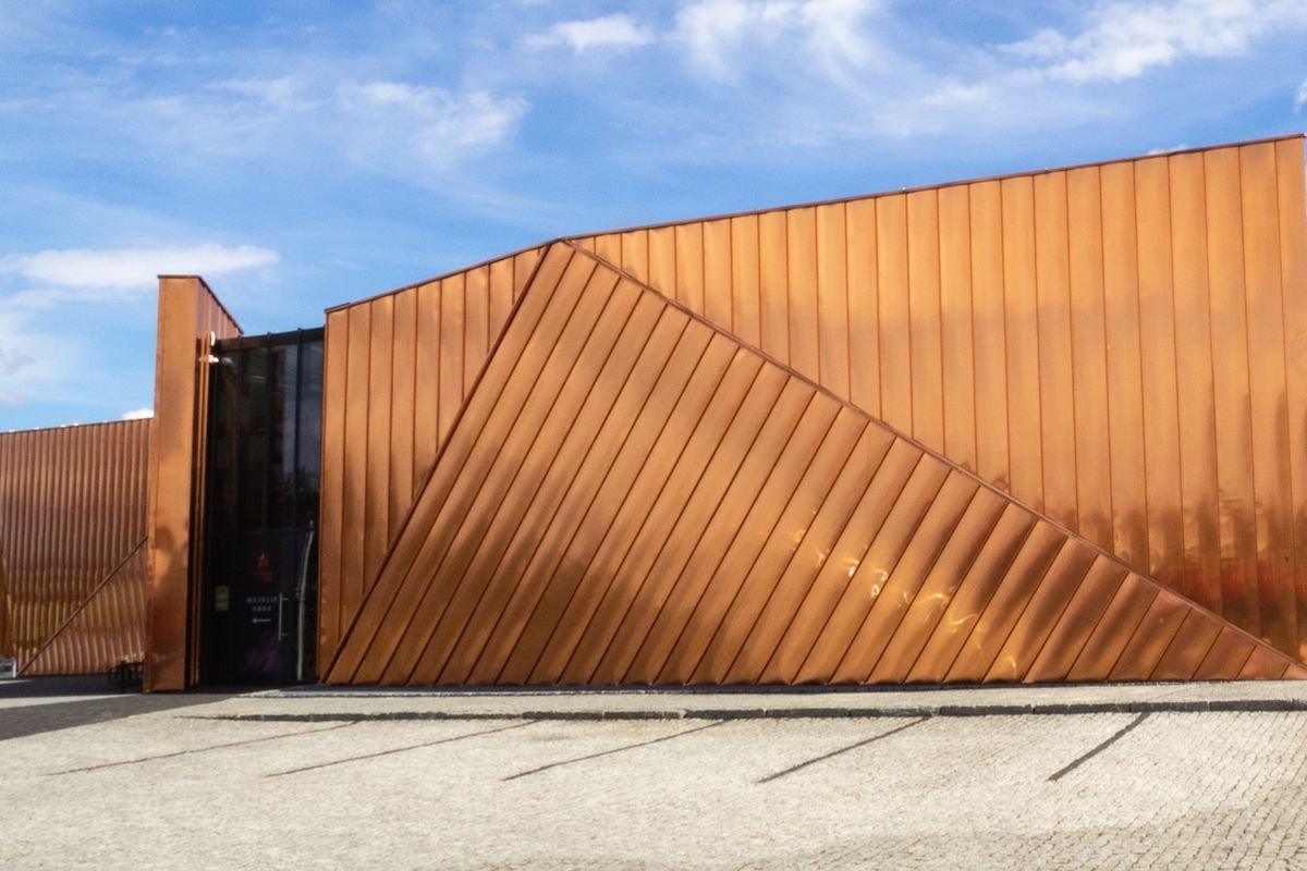 Copper-toned metal facade of a modern museum building