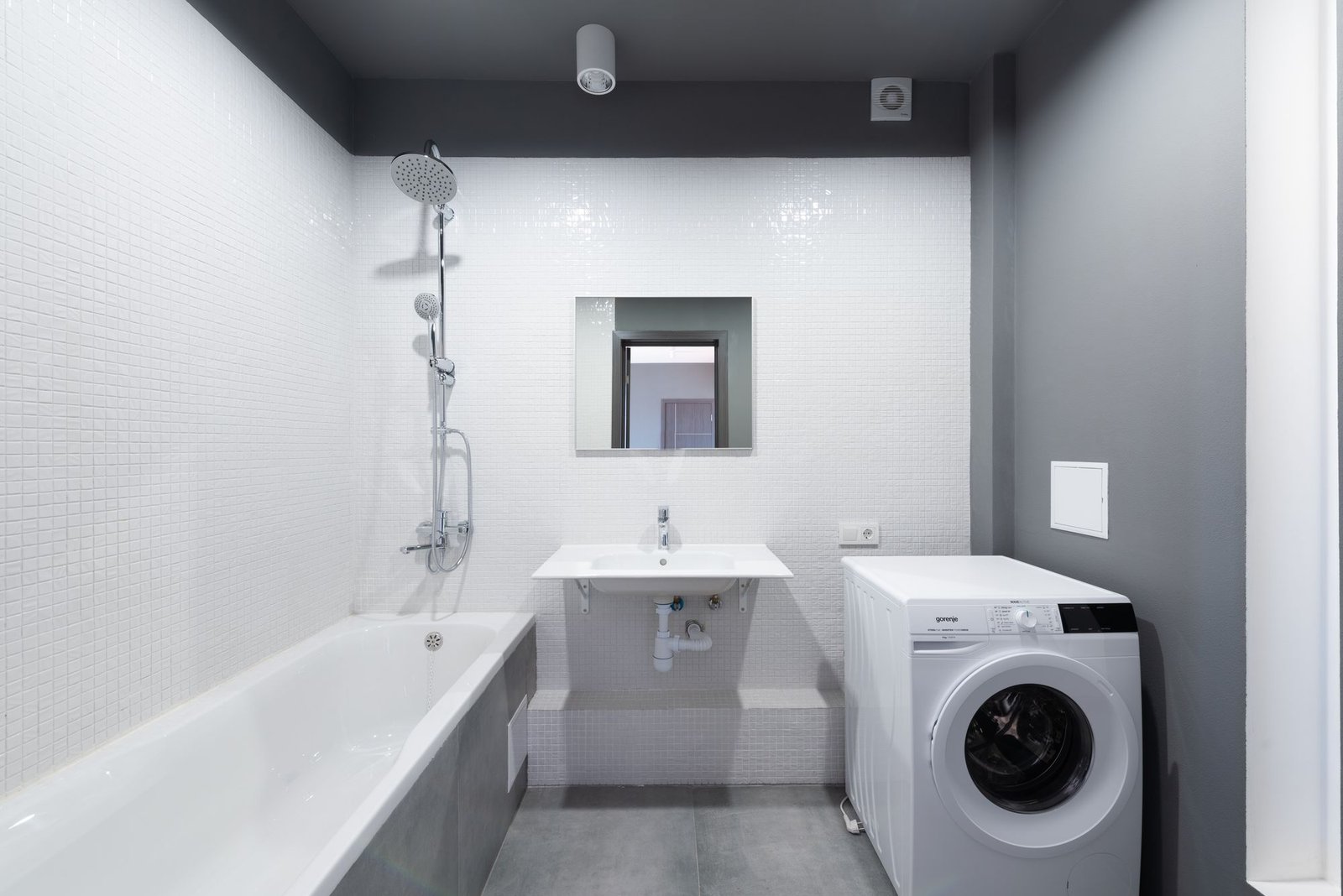 Freshly painted grey bathroom walls in a renovated apartment