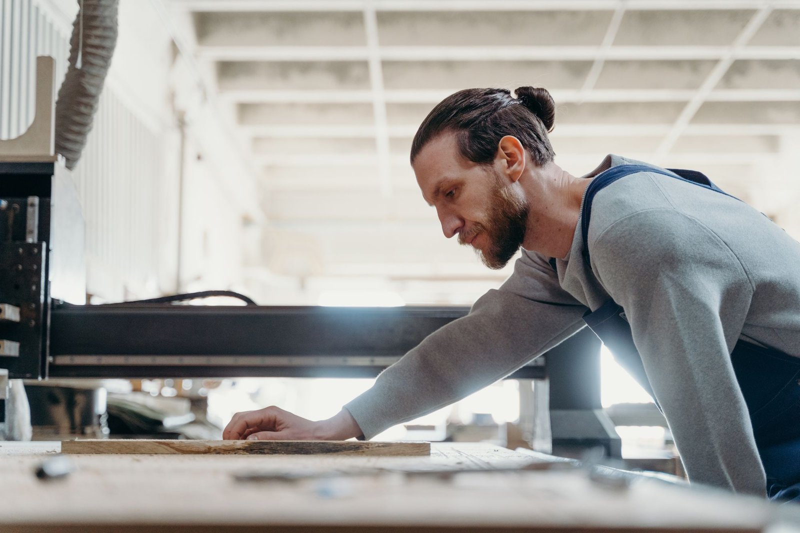 Artisan carpenter focused on a woodworking task in a modern workshop