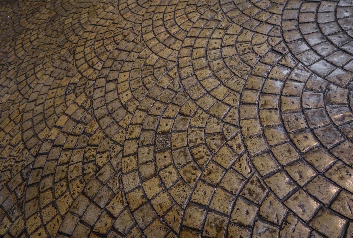Close-up of cobblestone paving laid in an intricate circular fan pattern