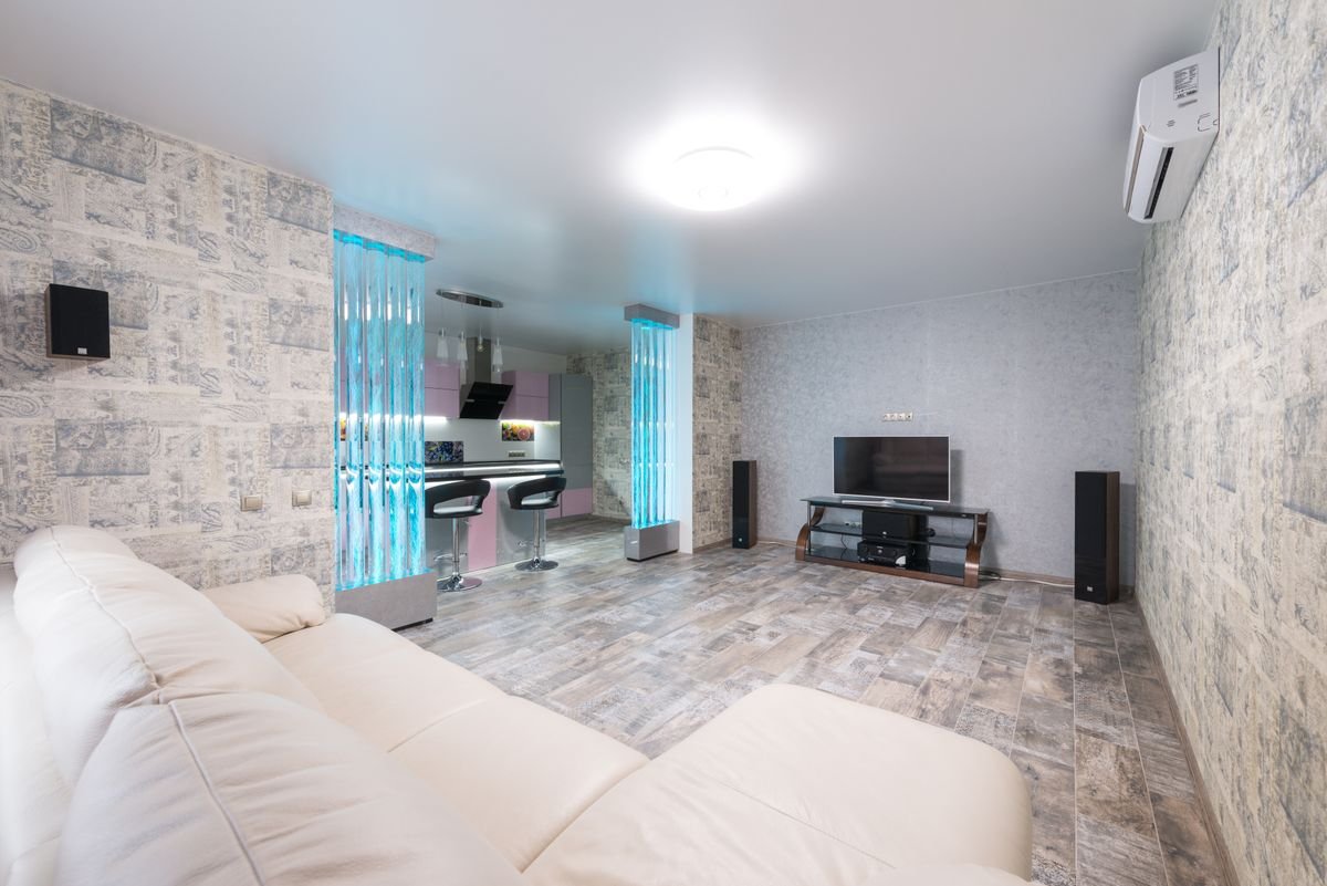 Living room with a textured grey feature wall and modern furniture