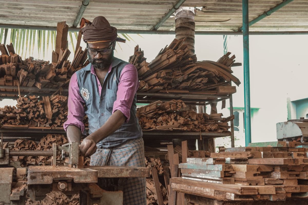 Carpenter demonstrating craftsmanship in a rustic workshop