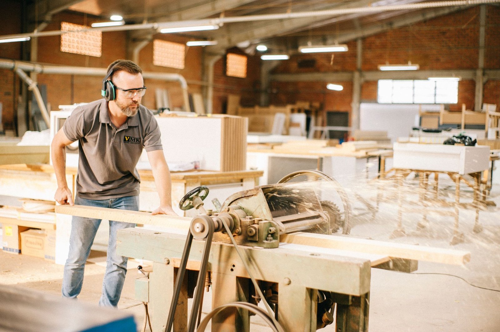 Skilled carpenter using machinery in a woodworking workshop