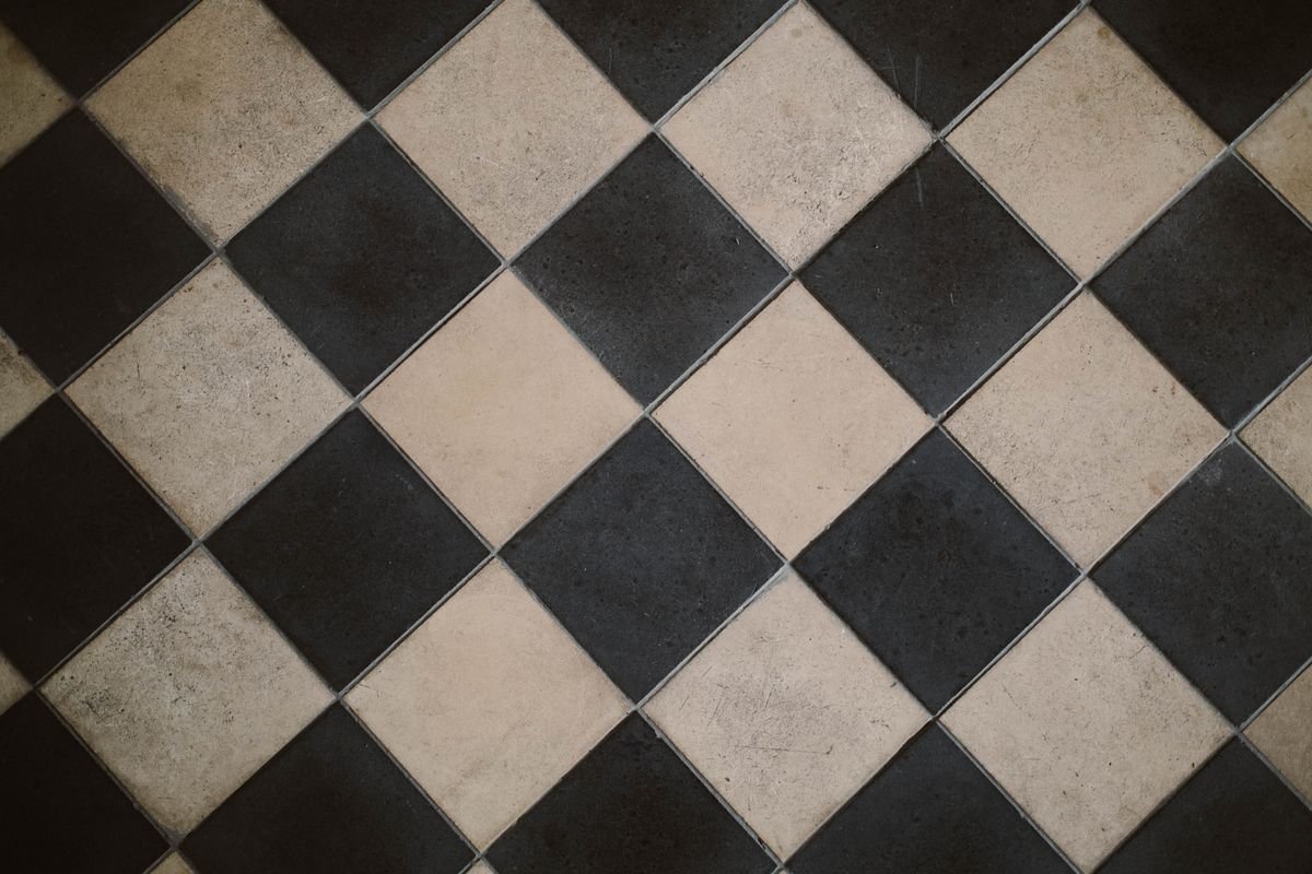 Diagonal black and white checkered ceramic floor tiles