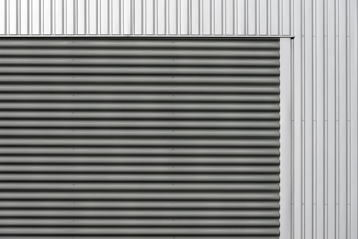 Minimalist metal facade with corrugated and smooth vertical panels