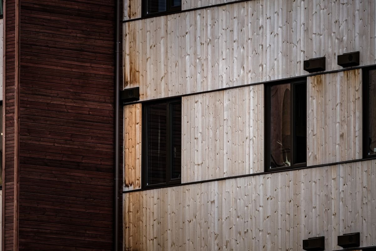 Modern building facade with alternating wooden panels and windows
