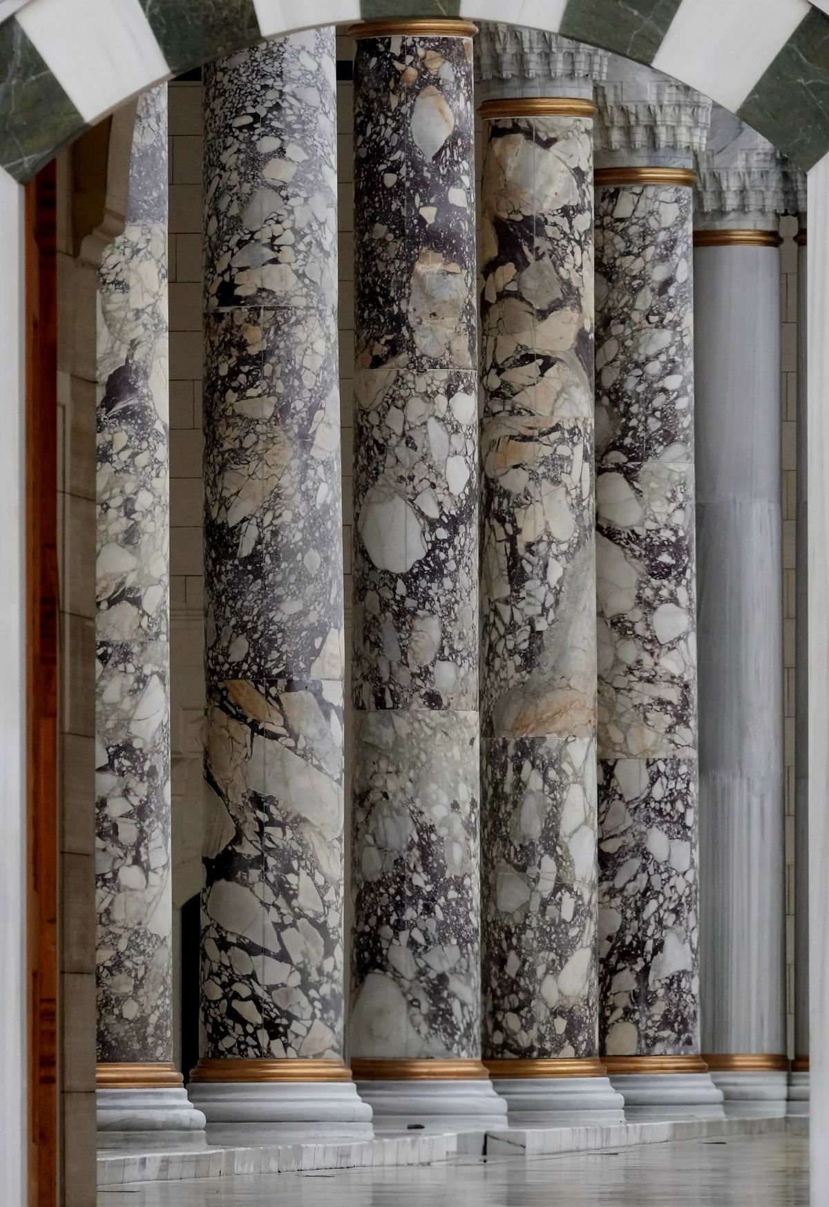 Row of veined marble columns in a grand entrance
