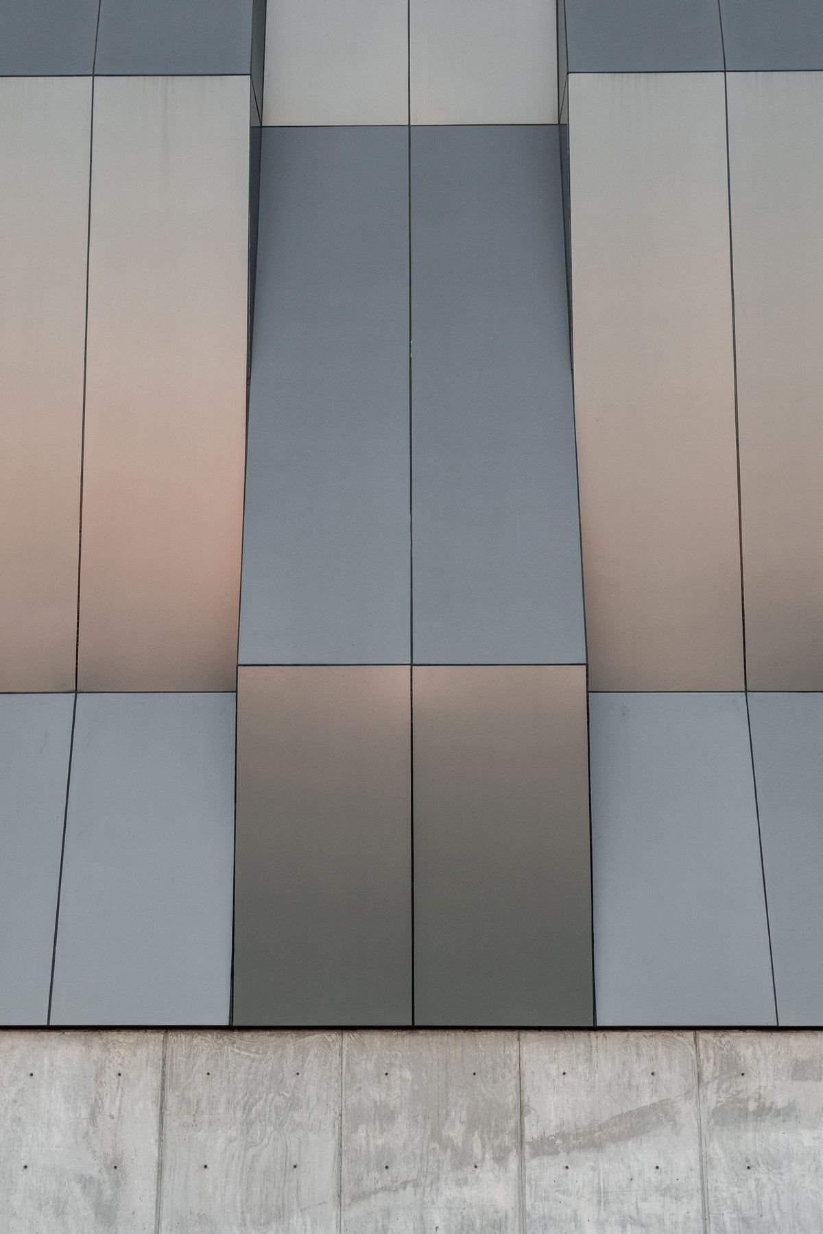 Contemporary building facade with sleek vertical panels and a minimalist design