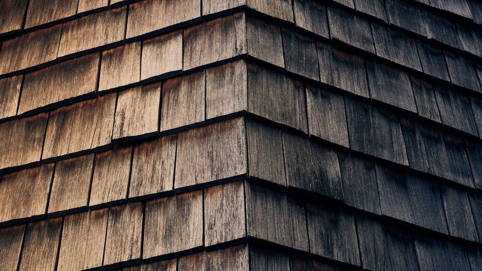 Detailed view of textured wooden shingles with a warm natural finish