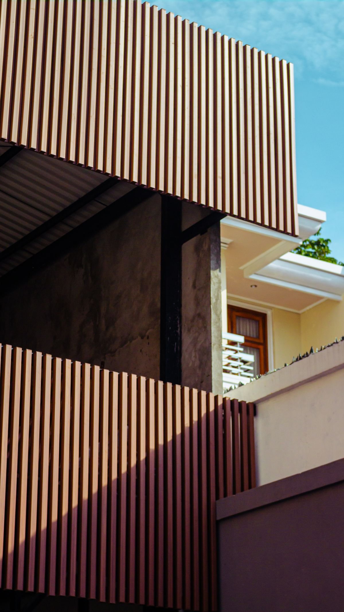 Contemporary building facade with wooden slats and angular design elements