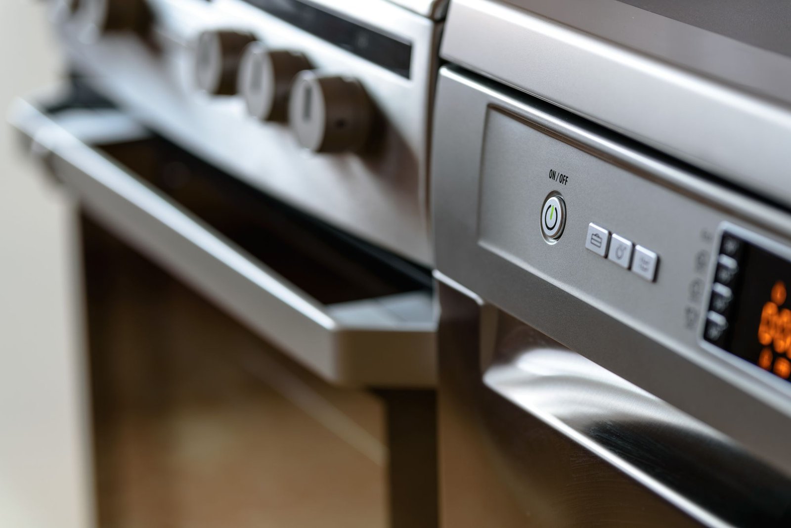 Modern stainless steel dishwasher and oven in a kitchen