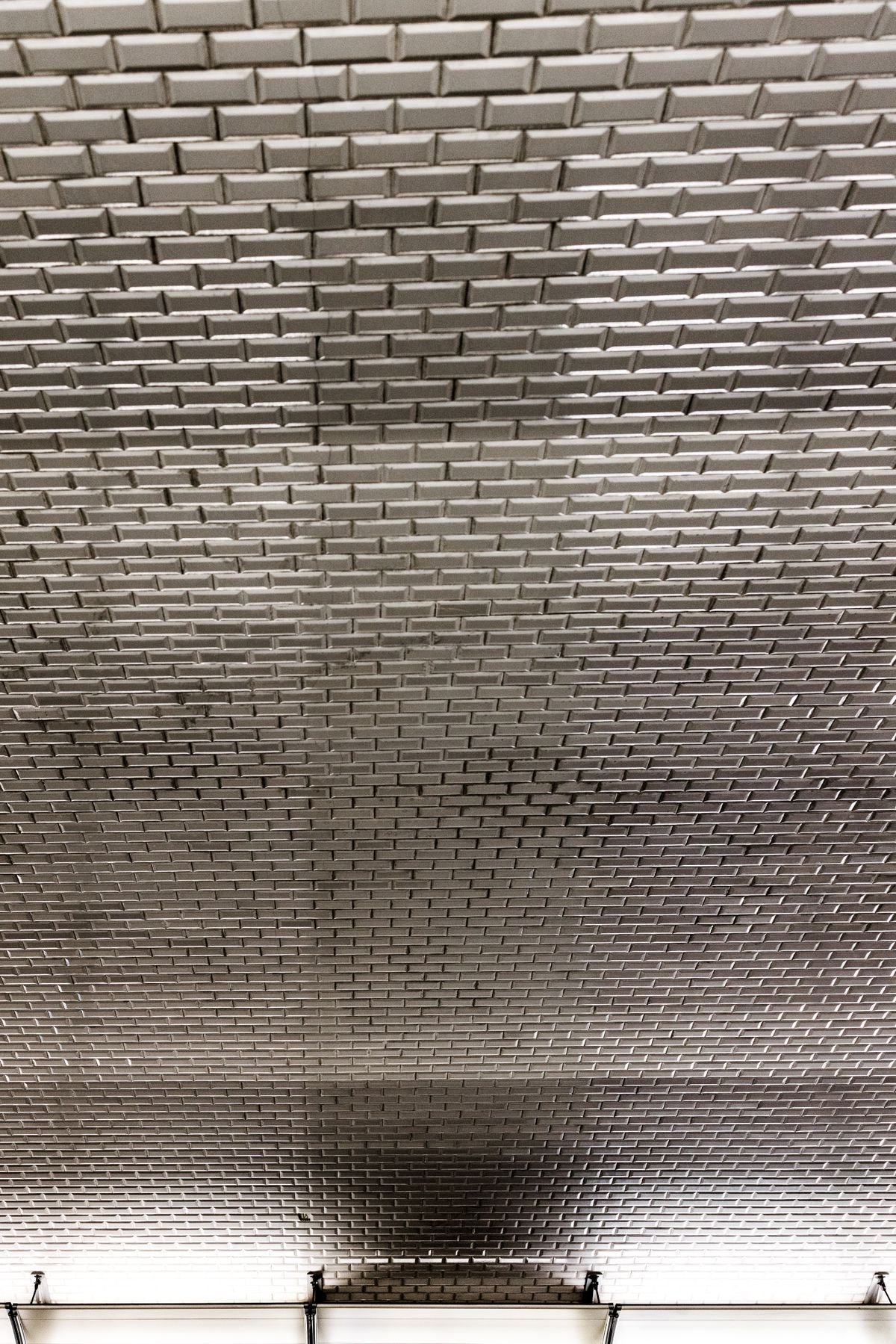 Reflective silver tile ceiling in a modern building