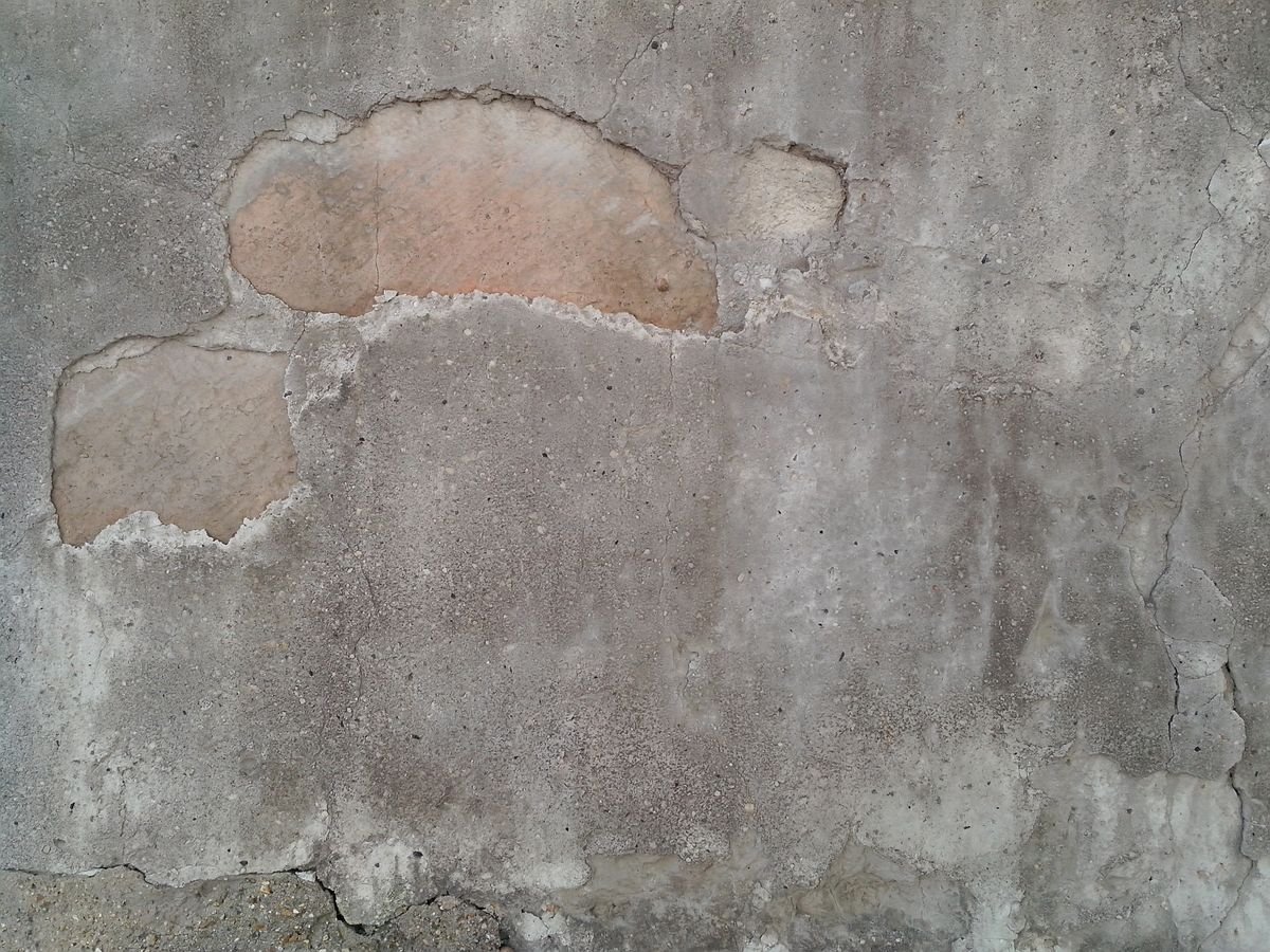 Wall surface showing patched areas of repaired plaster