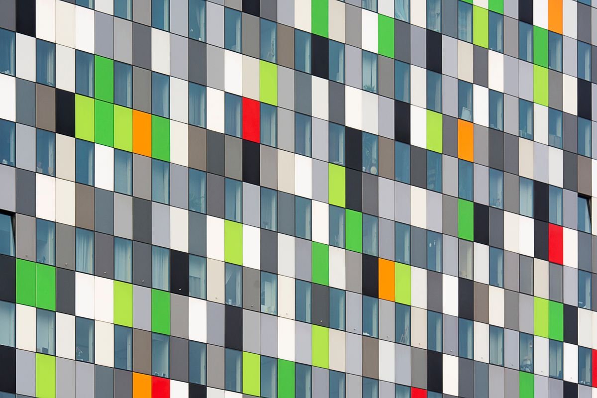 Vibrant geometric facade with multicoloured panels and windows