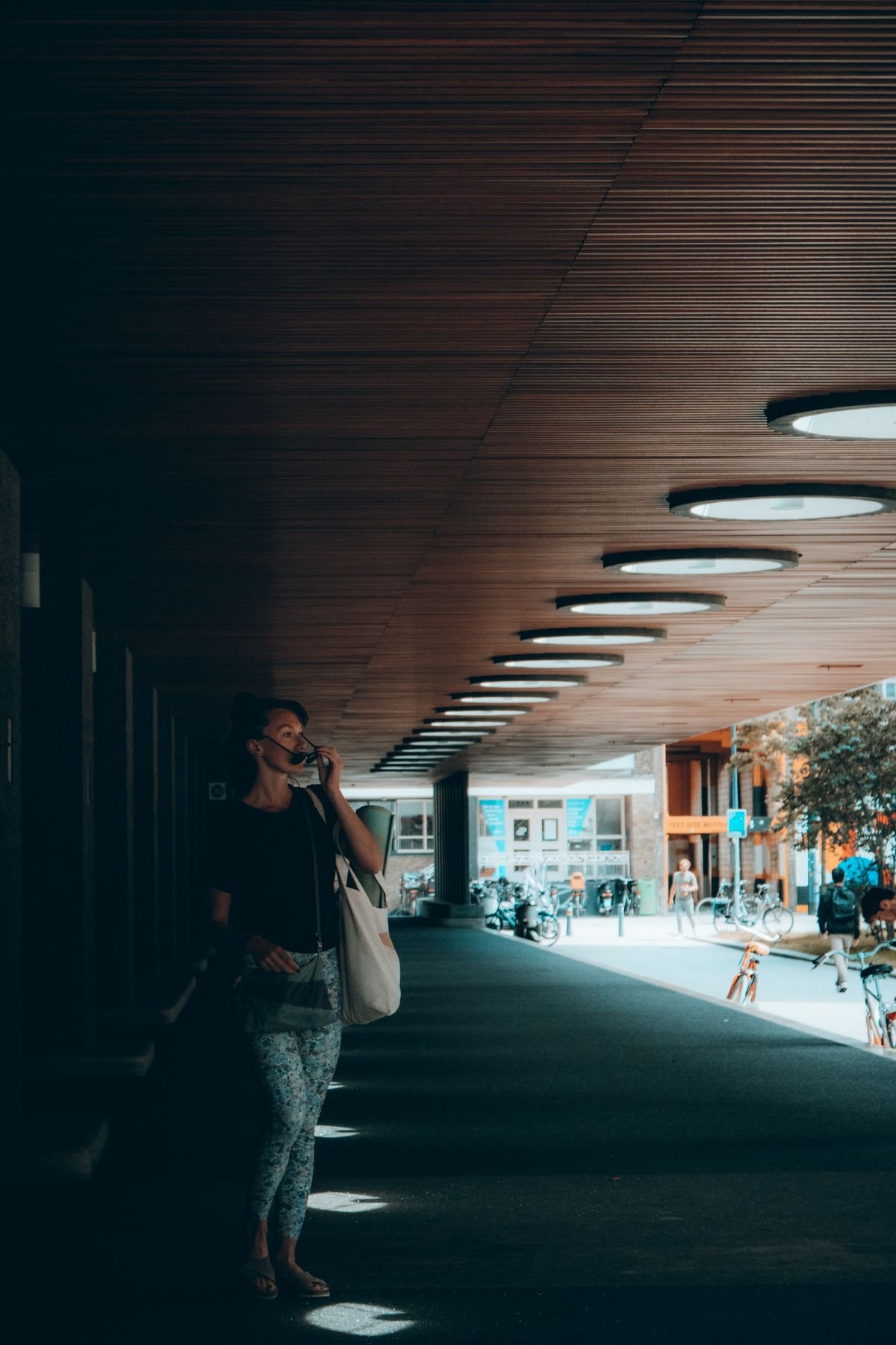 Dark timber-clad ceiling edge with a recessed light in a contemporary interior