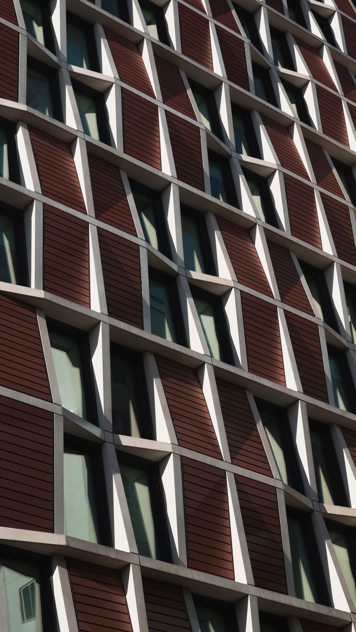 Modern building facade with geometric glass panels and a steel structure