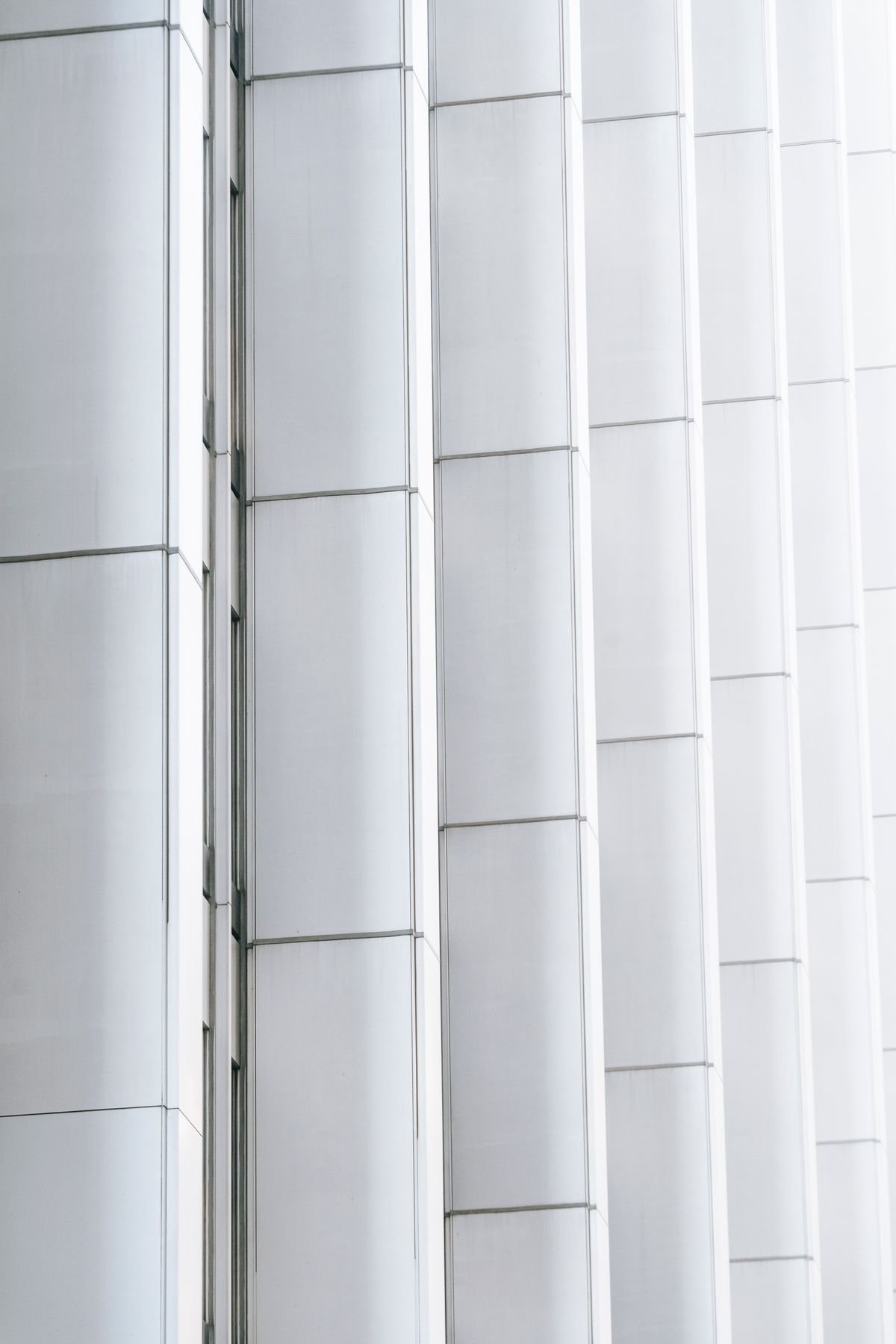 Rows of white geometric panels covering a contemporary building exterior