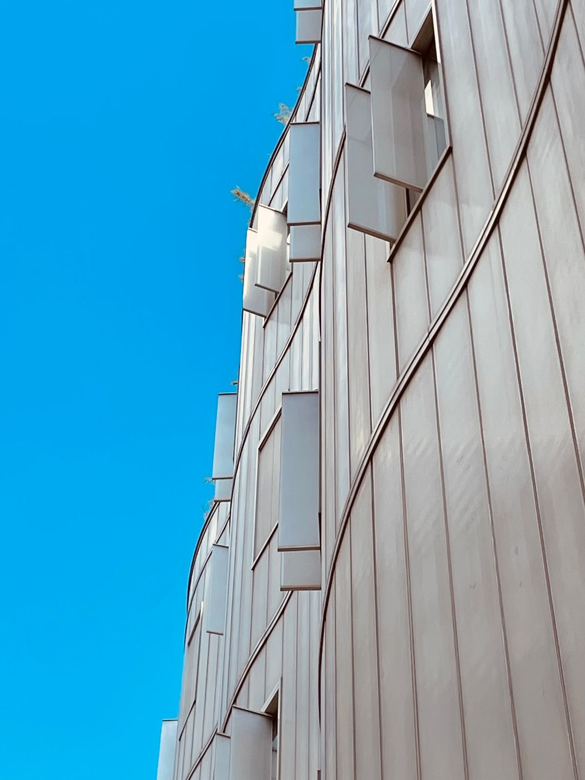 Modern facade with a repeating pattern and shutter panels