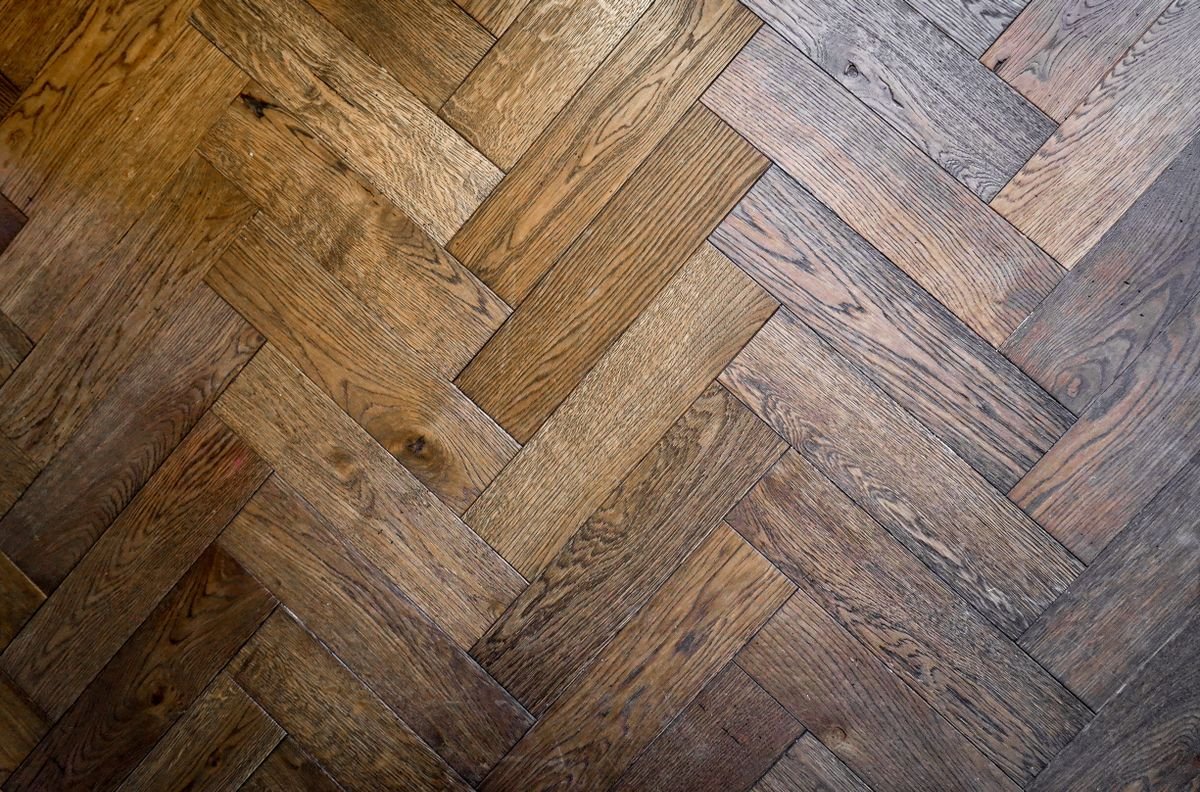 Stylish herringbone parquet floor pattern in warm wood tones