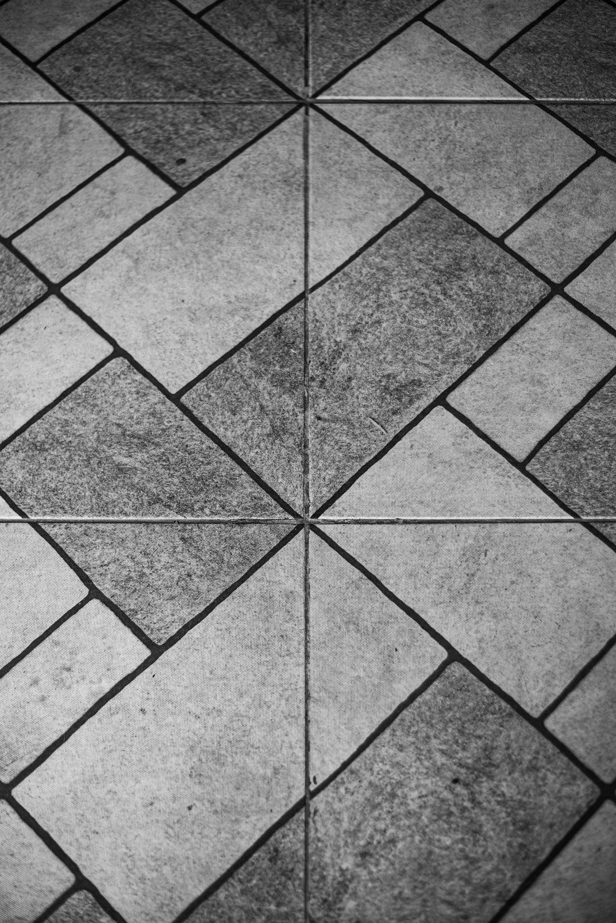 Black and white geometric stone floor tiles in an angular pattern