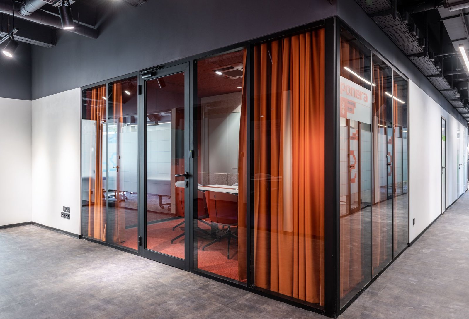 Modern glass partition wall in an office corridor