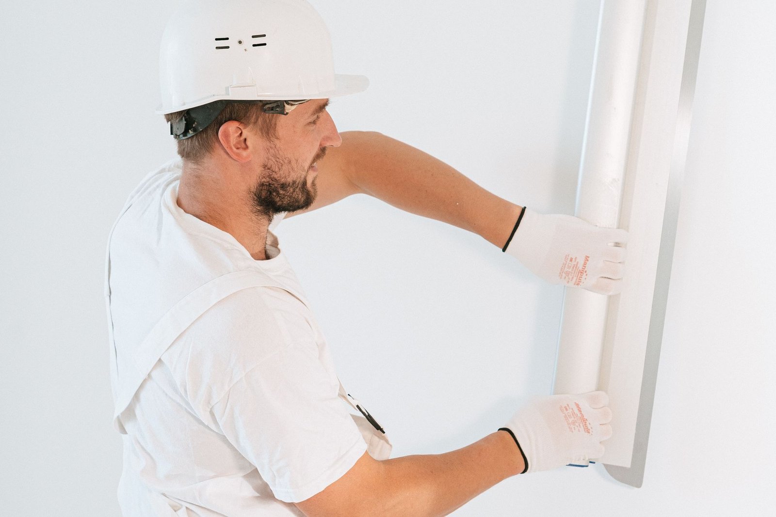 Construction worker installing a drywall partition wall
