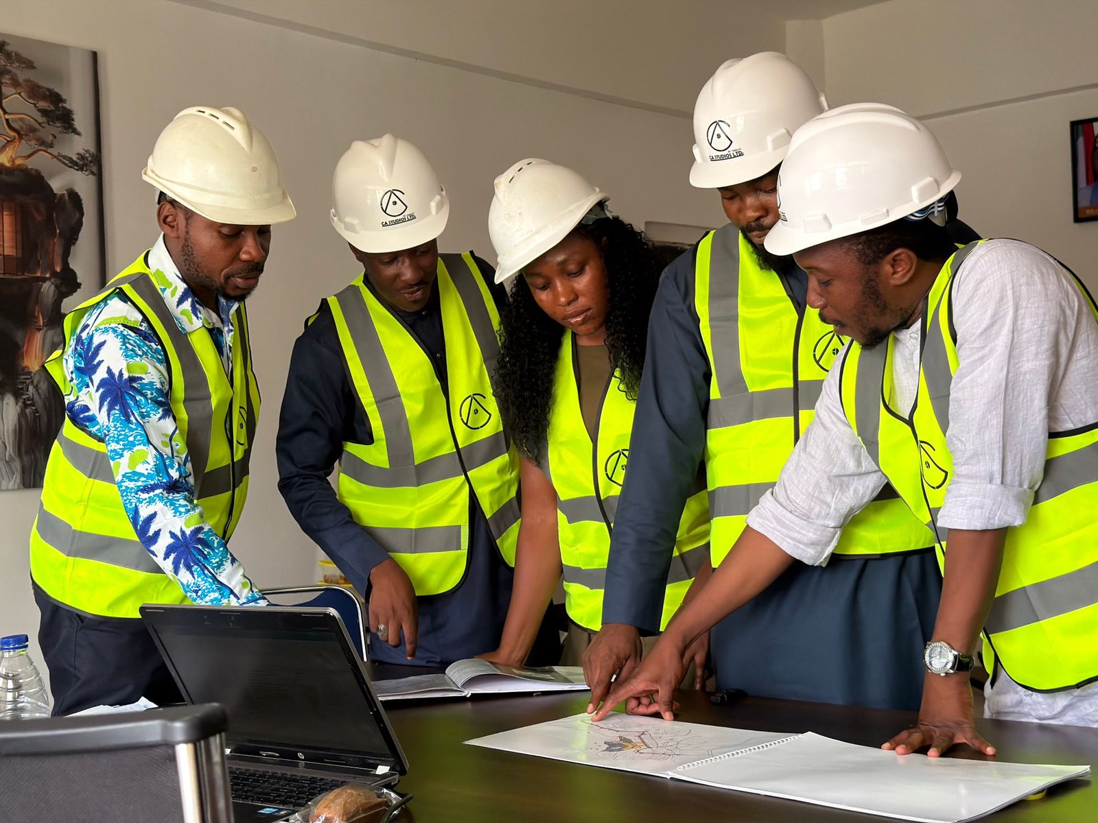 Team of engineers reviewing building plans on site