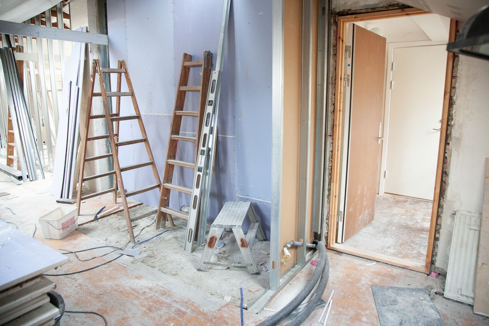 Interior room mid-renovation with drywall panels and metal framing