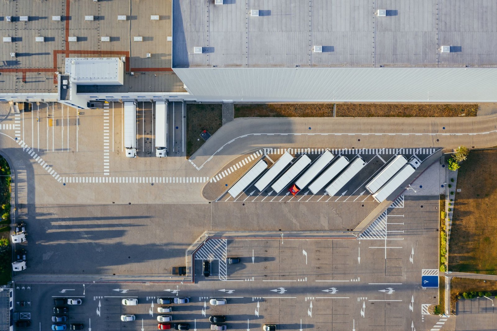 Aerial view of a logistics centre with a large paved truck yard and loading bays