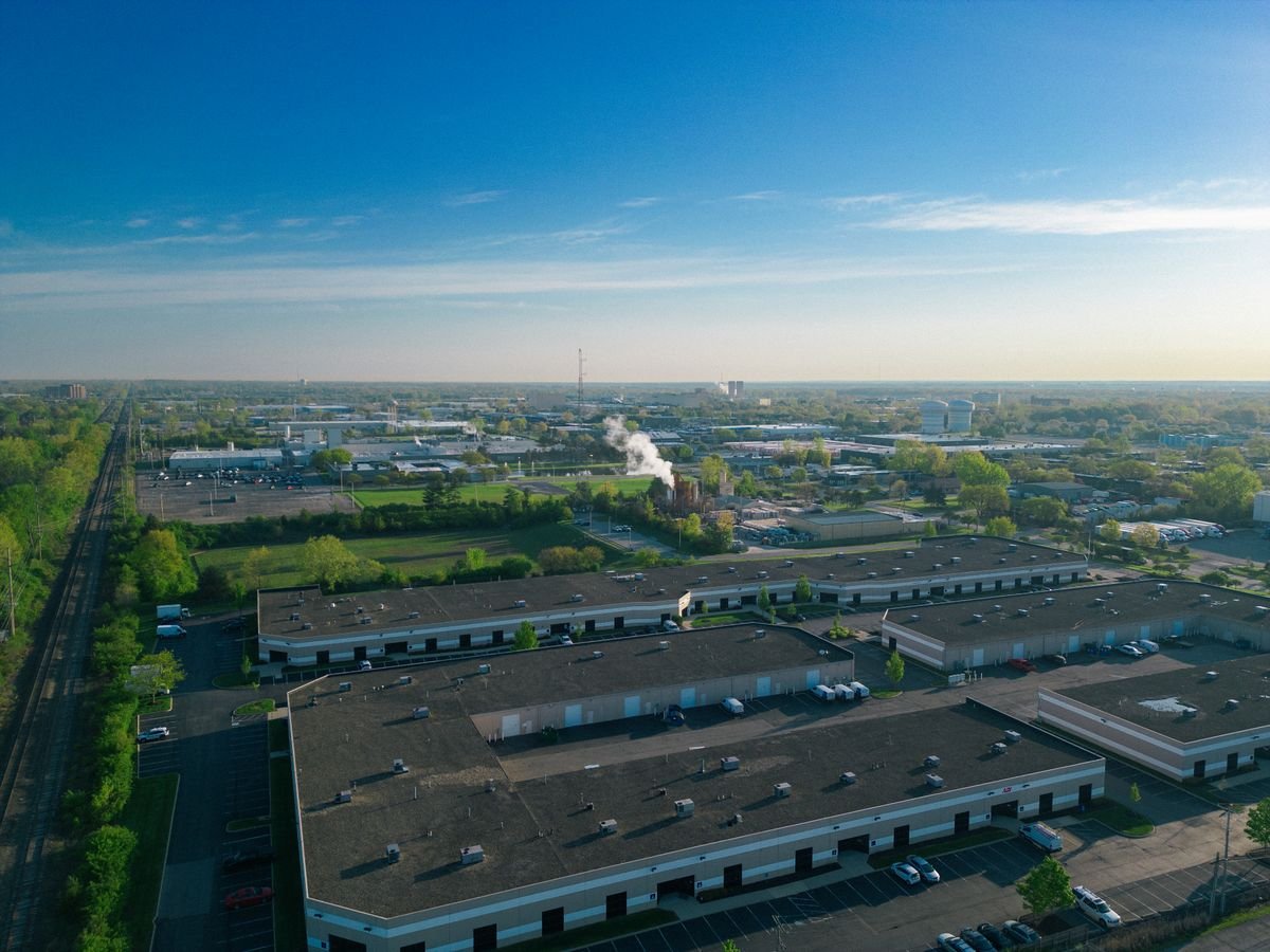 Large commercial building with an extensive paved car park and access roads
