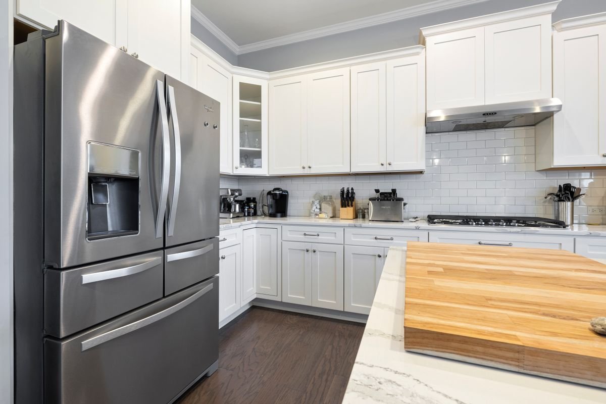 Kitchen with stainless steel hood and appliances