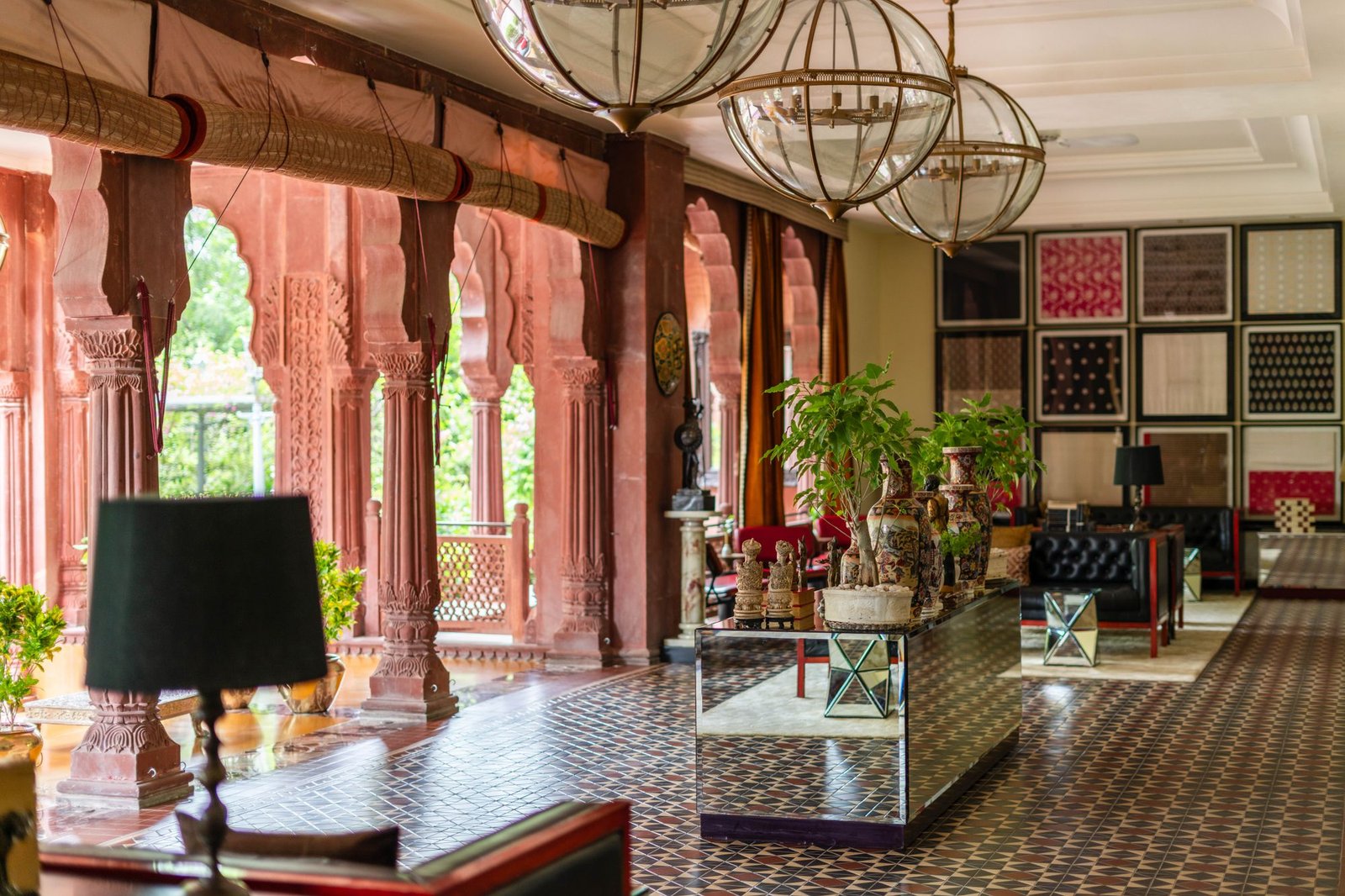 Grand hotel-style lobby with carved arches, chandeliers, and layered decorative furnishings
