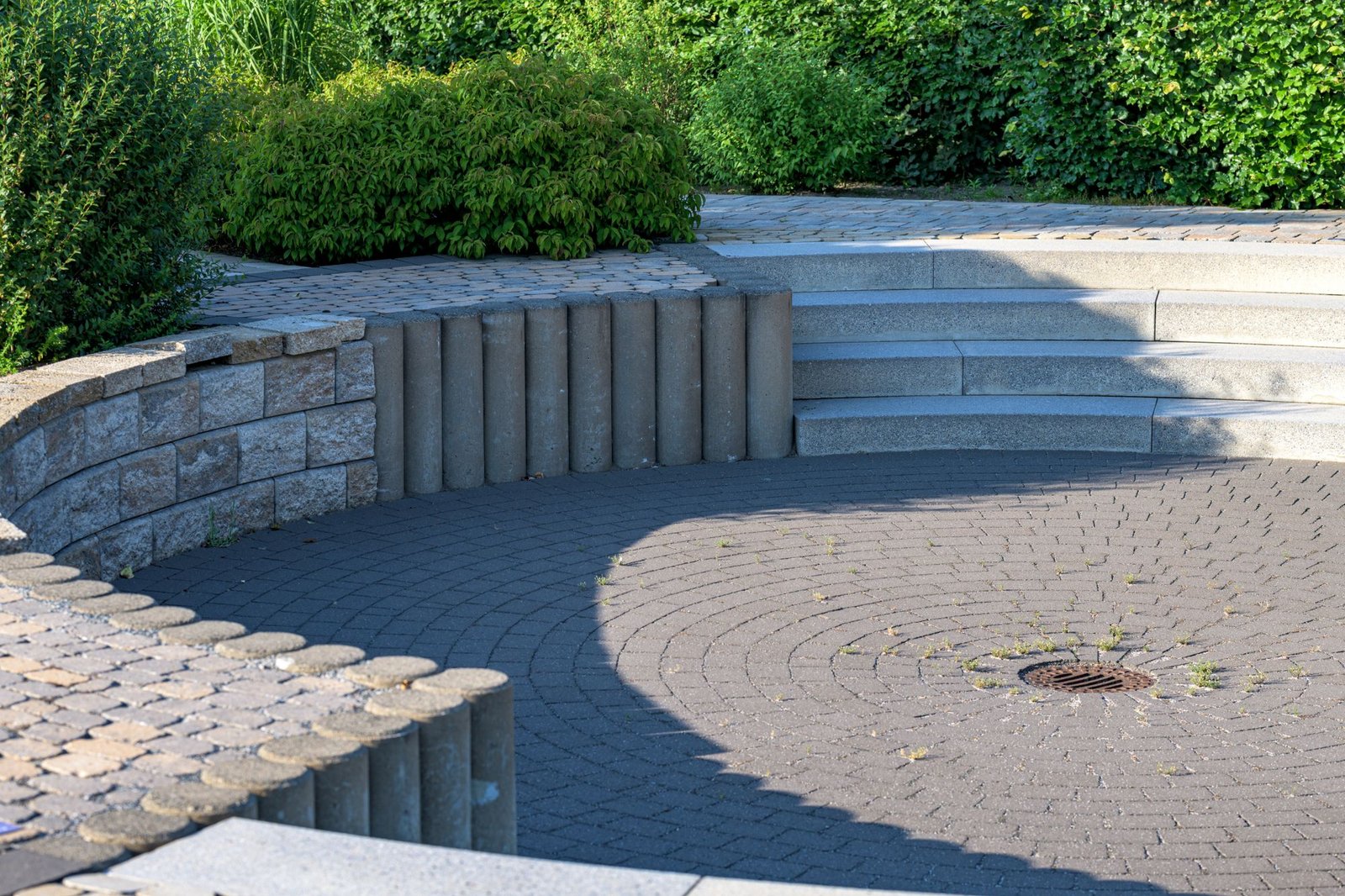 Circular interlock paver patio with retaining wall and steps