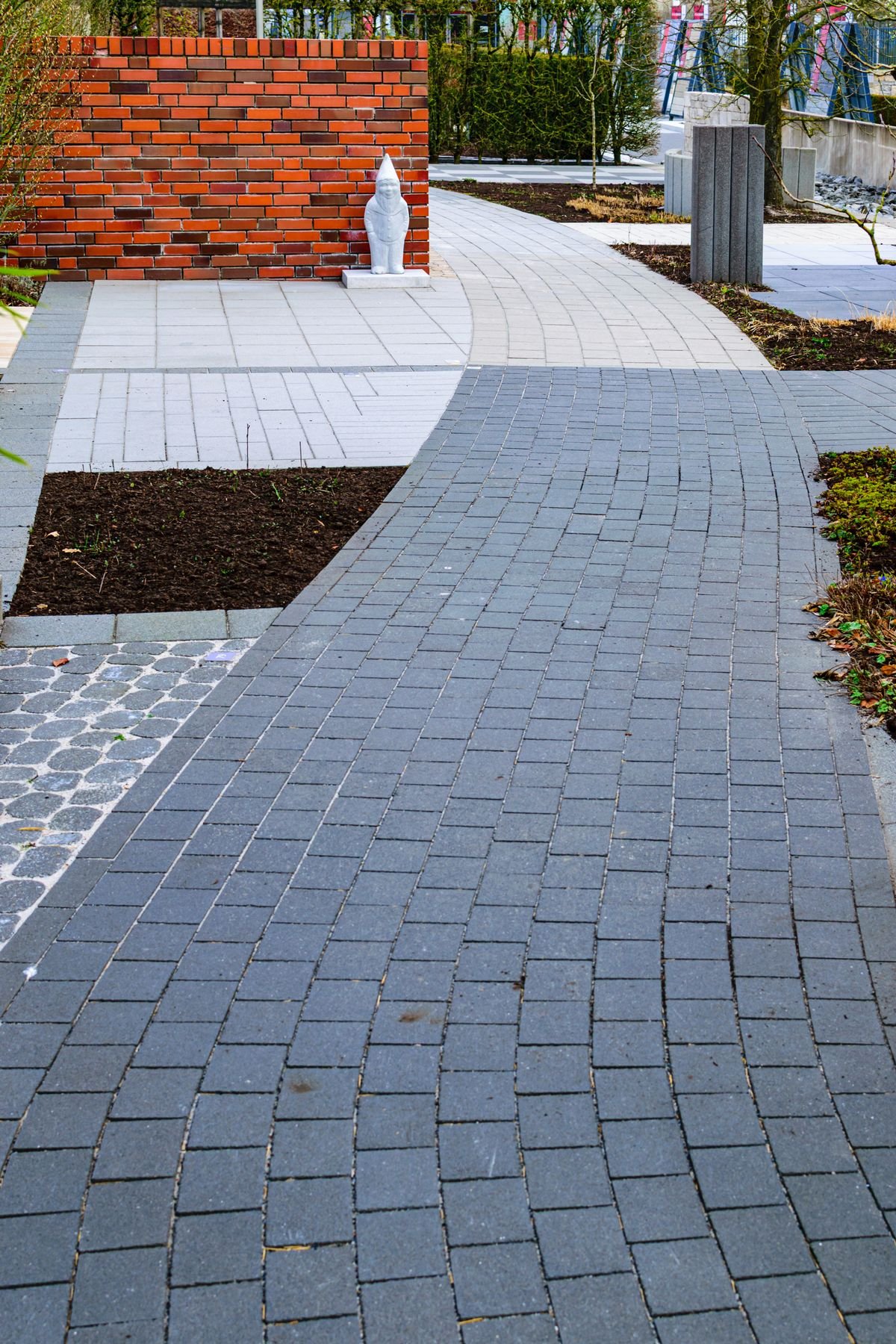 Curved brick interlock pathway in a garden setting
