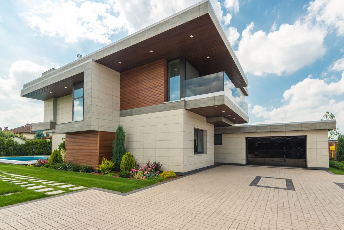 Contemporary house with pale interlock paving leading to the garage