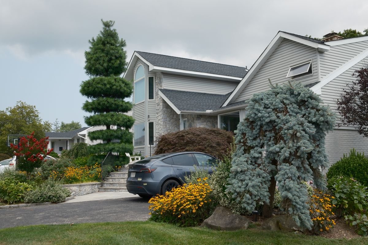 Suburban home with a paved driveway and landscaped front garden