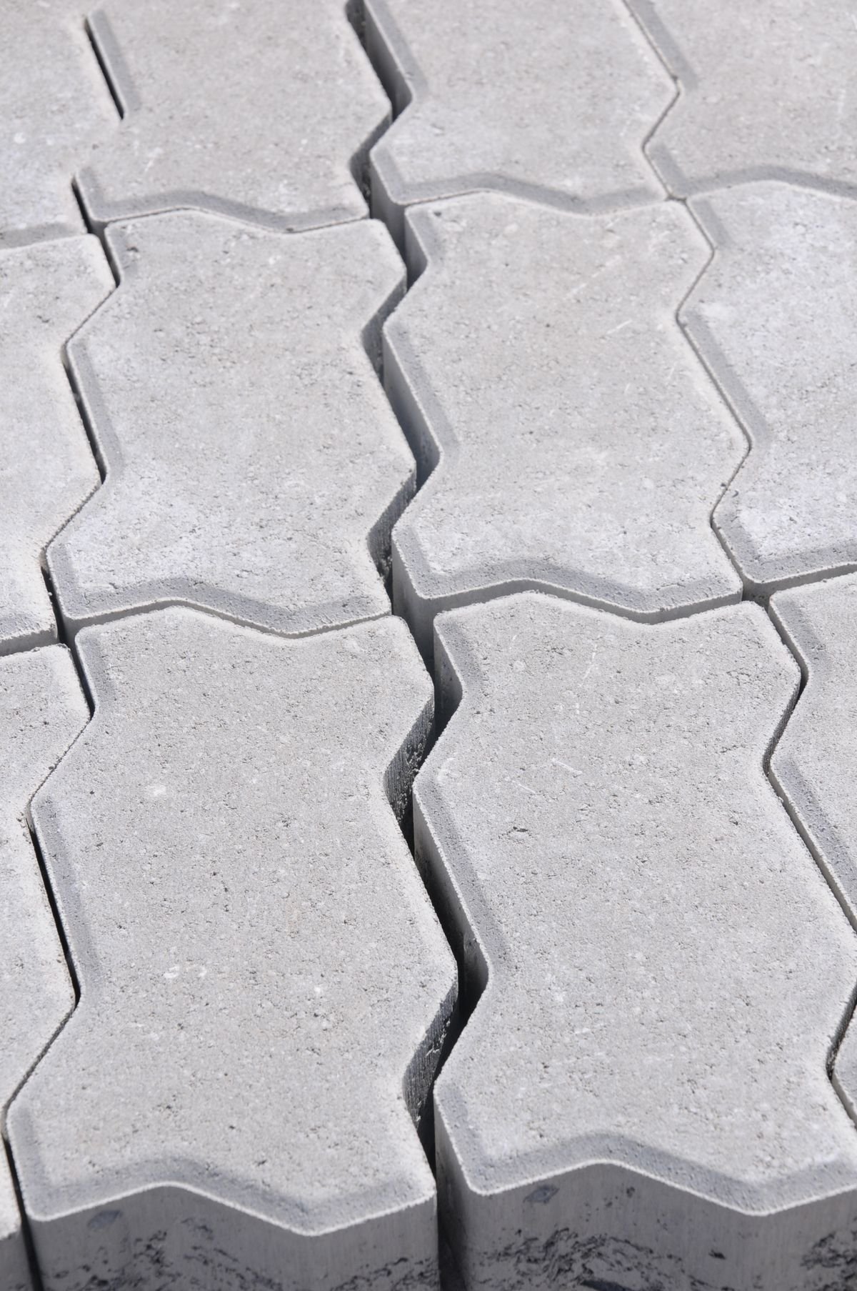 Close-up of grey interlocking paver stones laid in a locking pattern
