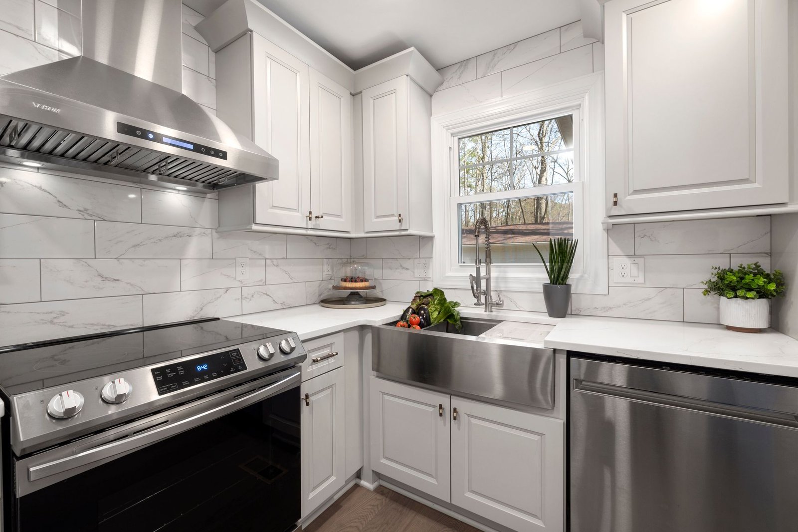 Stainless steel range hood over a stove in a modern kitchen