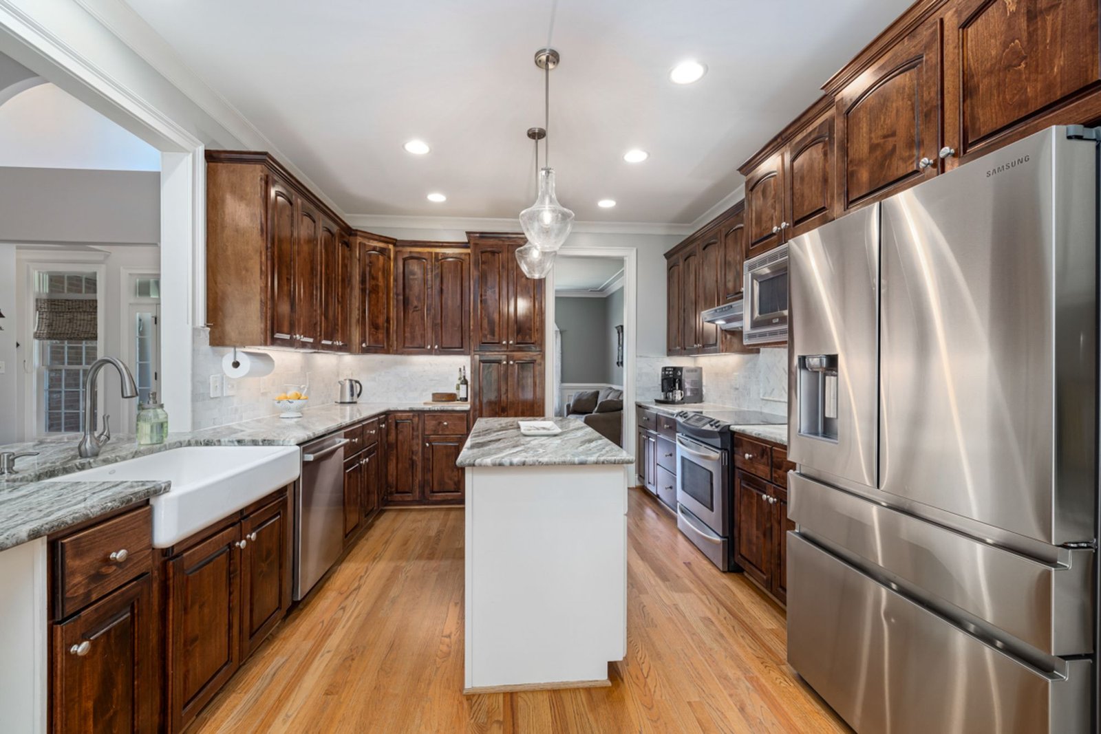 Spacious modern kitchen with wooden cabinets and stainless steel appliances
